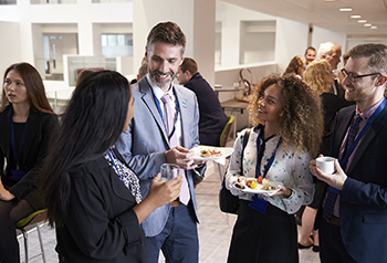 Delegates networking during conference lunch break.