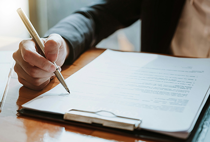 A person signing a contract.