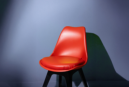 A single seat with a spotlight shining on it.