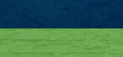 A dark block on top of a light blue brick wall. 