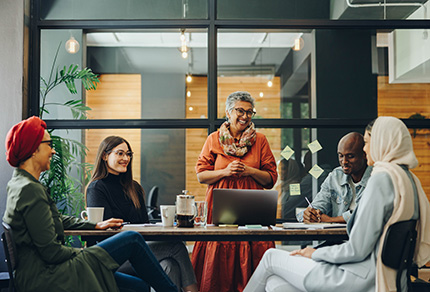 A diverse group of individuals collaborating on a project, sharing ideas and working together in a professional setting.