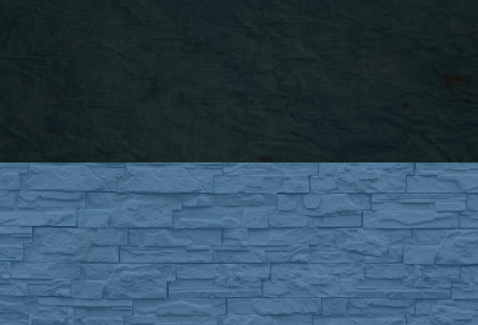 A dark block on top of a blue brick wall. 
