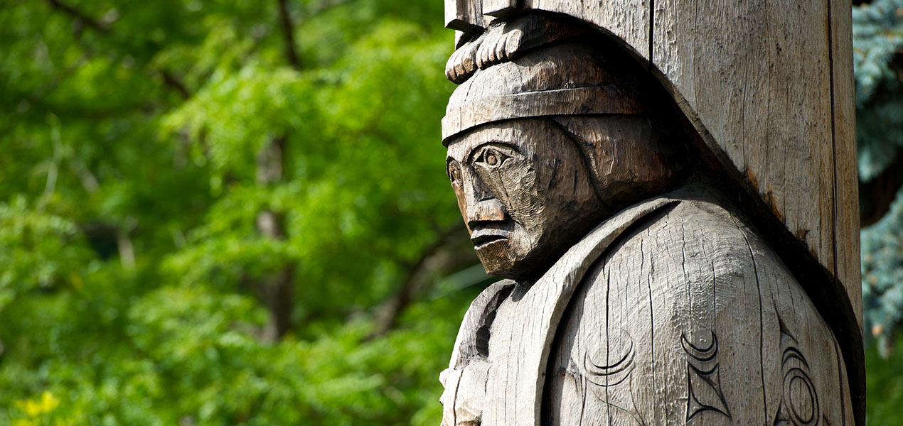 Detail of totem pole located in Duncan, British Columbia. Wood carving representation of a person.