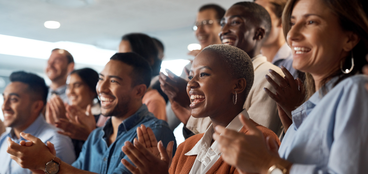 A diverse group of professionals applauding