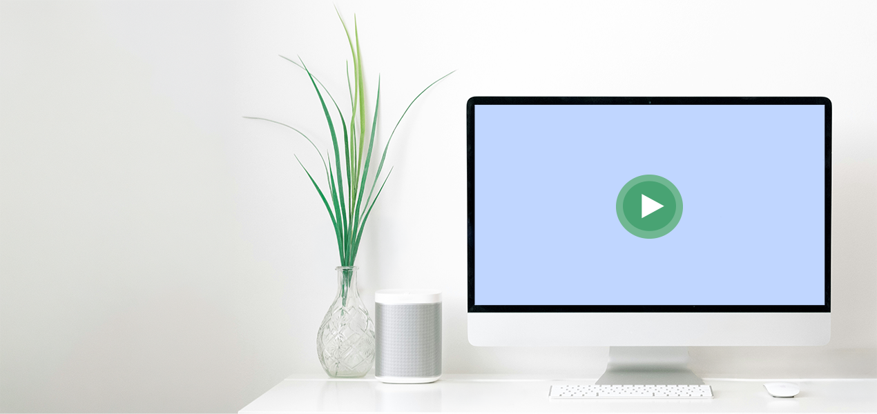 A large computer on a desktop with a play button in the middle of the screen.