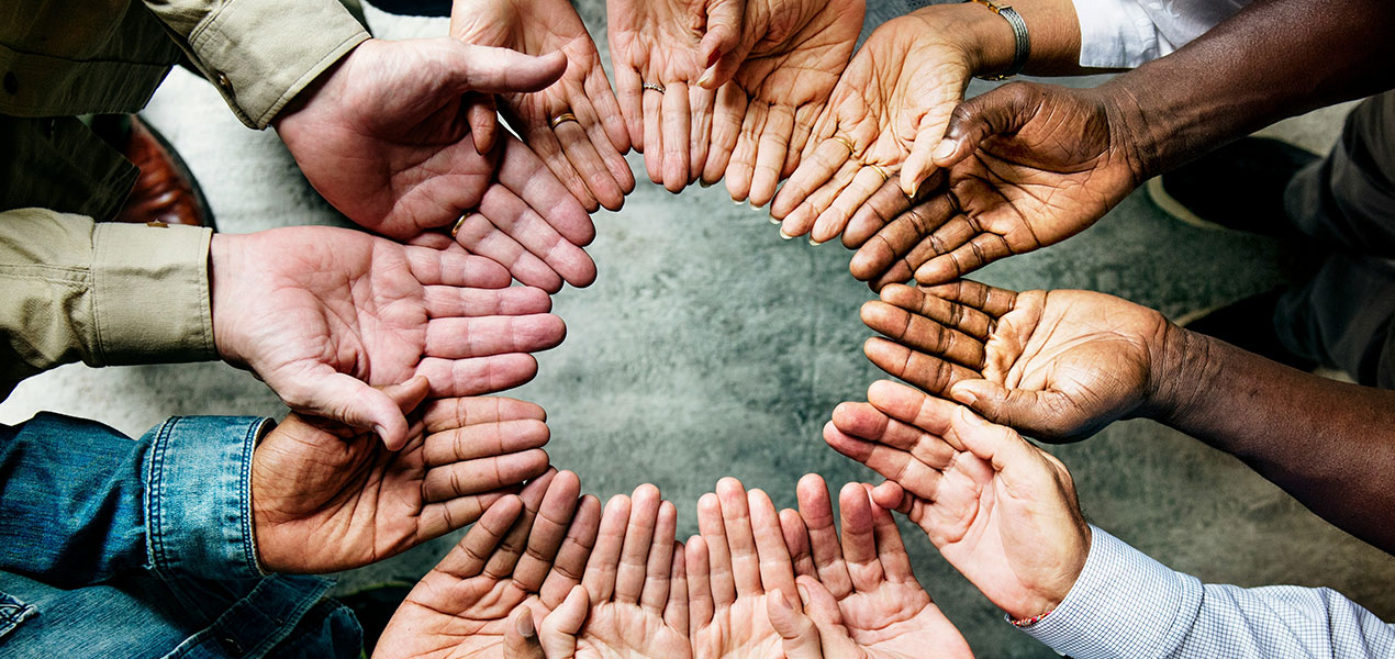 A circle of upturned hands. 