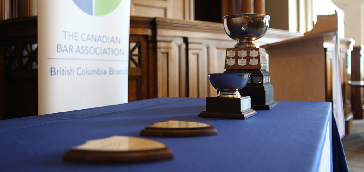 The Barry Sullivan Law Cup trophy sitting on a table with a podium in the background.