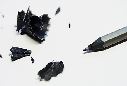 A sharpened pencil surrounded by shavings.