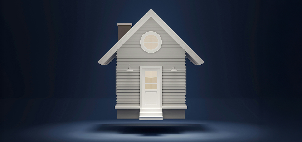 A model house floating above a table.