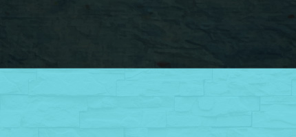 A dark block on top of a green brick wall. 