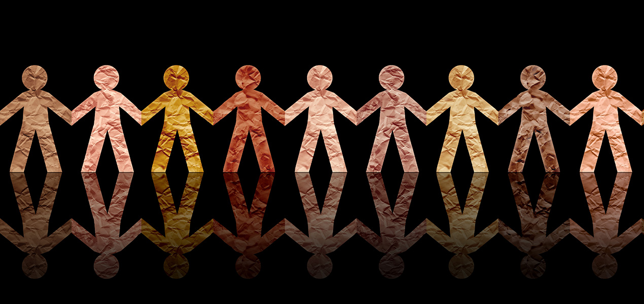 Paper cut-outs of people all in a row depicting diversity.