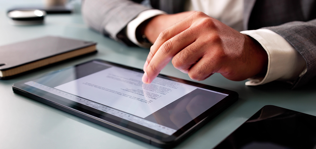 Close up of a person scrolling on an iPad.
