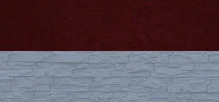 A dark block on top of a light blue brick wall. 