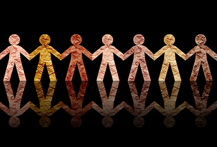 Paper cut-outs of people all in a row depicting diversity.