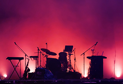 An empty stage with a full set of instruments.