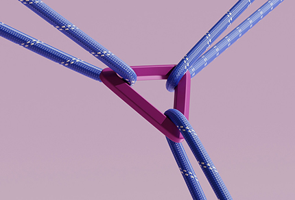 A rock climbing clip holding three ropes together.