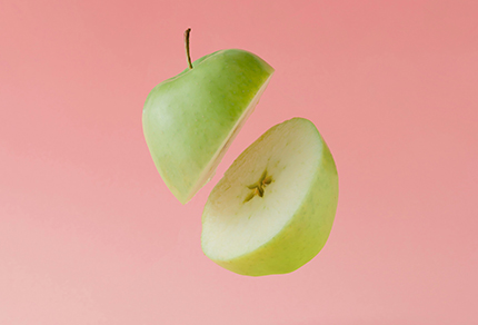 An apple cut in half floating in the air.