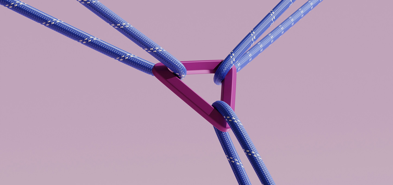 A rock climbing clip holding three ropes together.