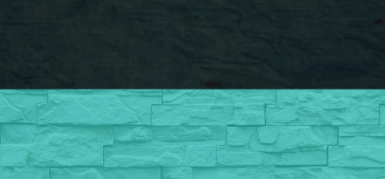 A dark block on top of a light blue brick wall. 