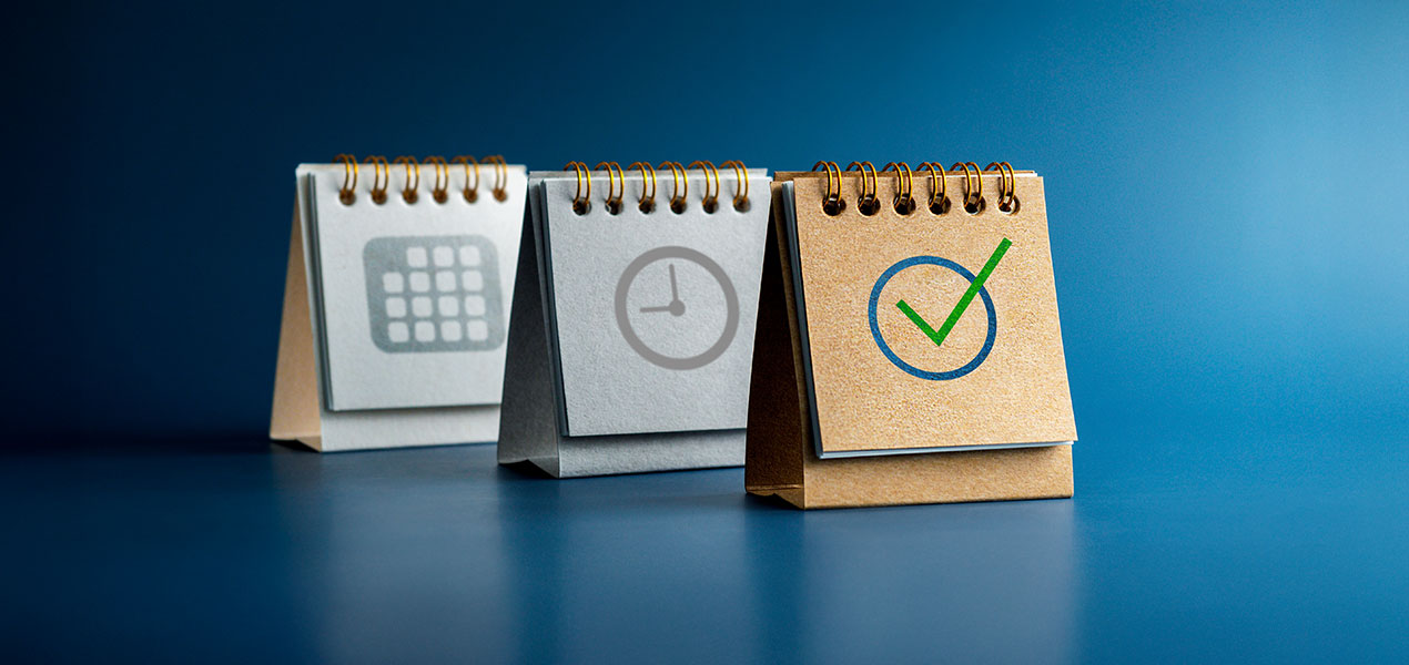 Three flip charts with a calendar, a clock and a checkmark.