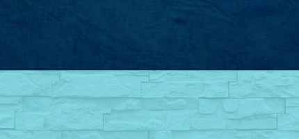 A dark block on top of a green brick wall. 