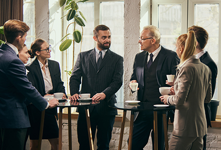 A group of professionals meeting over coffee.
