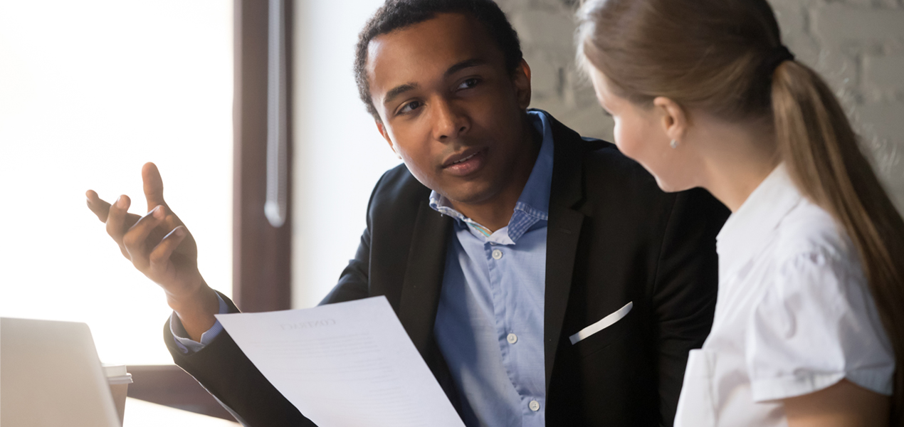 Black male discussing contract details with woman.