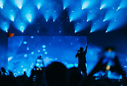 A band performing on stage in front of a large crowd.