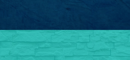 A dark block on top of a light blue brick wall. 