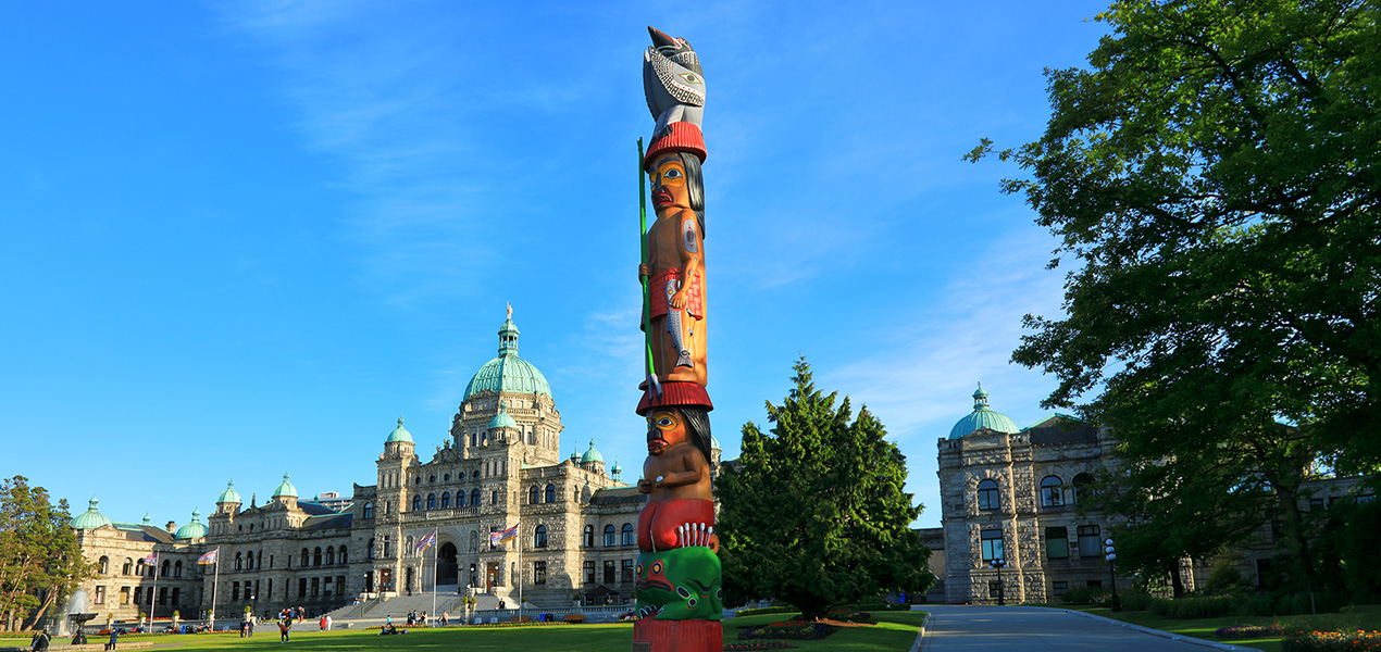 An Indigenous totem in front of the BC legislature building.