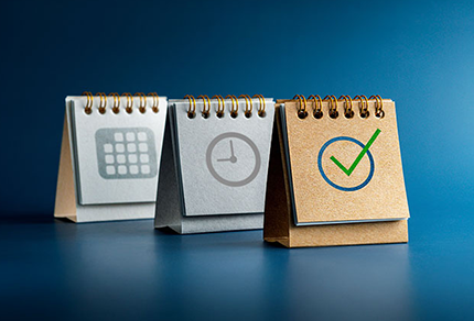 Three flip charts with a calendar, a clock and a checkmark.