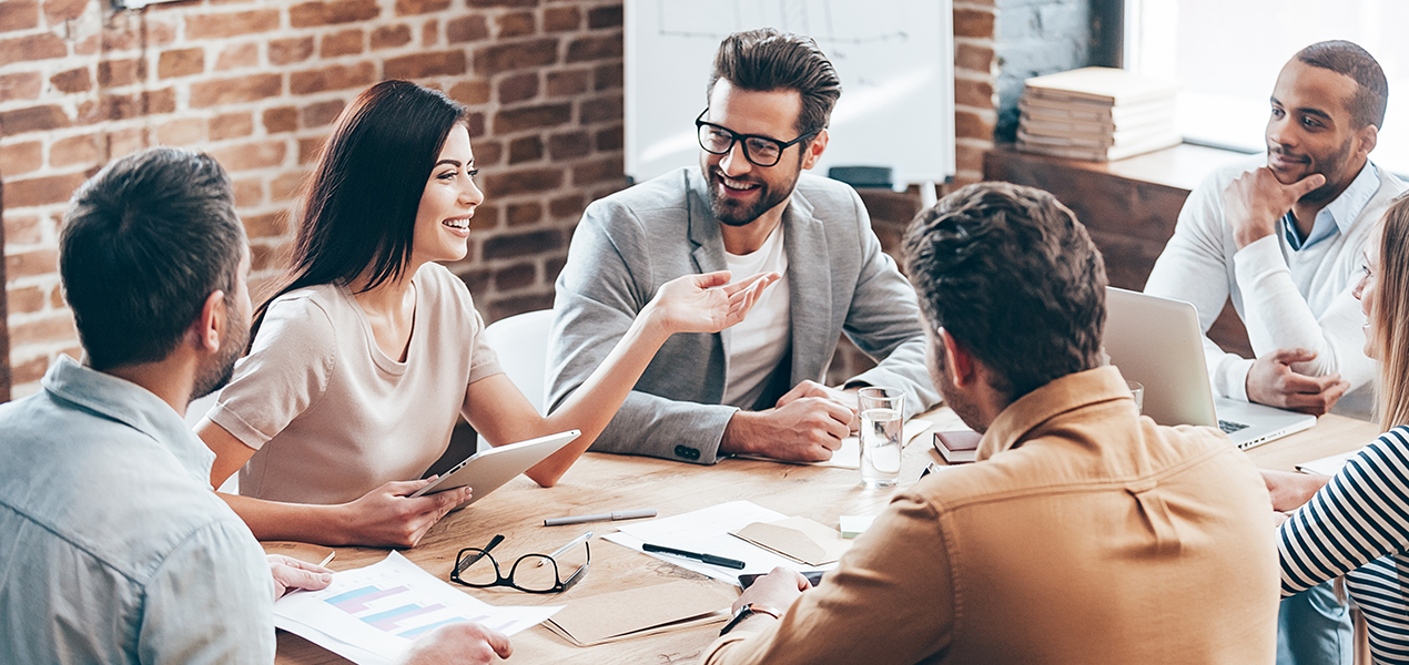 A group of people sitting around a table meeting