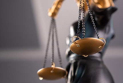 Close-up of Lady Justice holding scales.