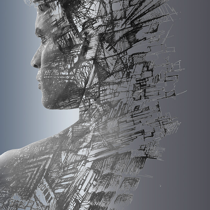 An aerial view of a person standing on pavement with a Canadian flag at their feet.